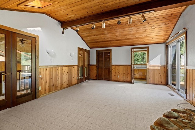 interior space featuring track lighting, french doors, wood ceiling, and lofted ceiling with skylight