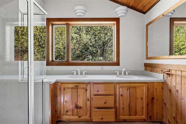 bathroom with wooden ceiling, vaulted ceiling, large vanity, and double sink