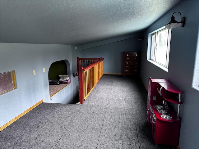 interior space featuring vaulted ceiling and a textured ceiling