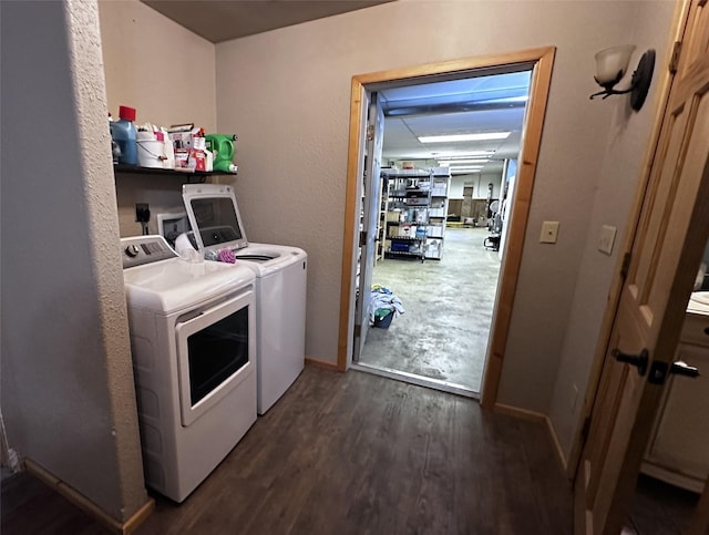 laundry area featuring washing machine and clothes dryer and dark hardwood / wood-style flooring