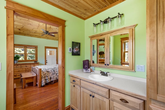 bathroom with a ceiling fan, wood ceiling, ensuite bathroom, crown molding, and vanity