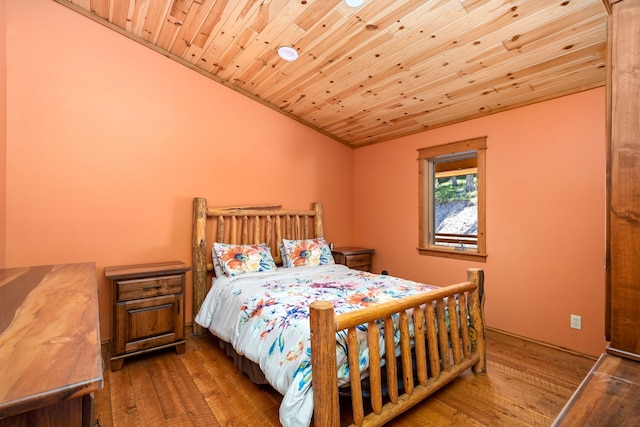 bedroom with wooden ceiling, vaulted ceiling, and hardwood / wood-style floors