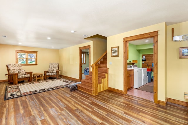 sitting room with baseboards, light wood finished floors, and stairs