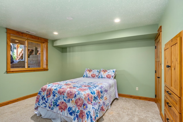 bedroom featuring carpet flooring, a textured ceiling, and baseboards