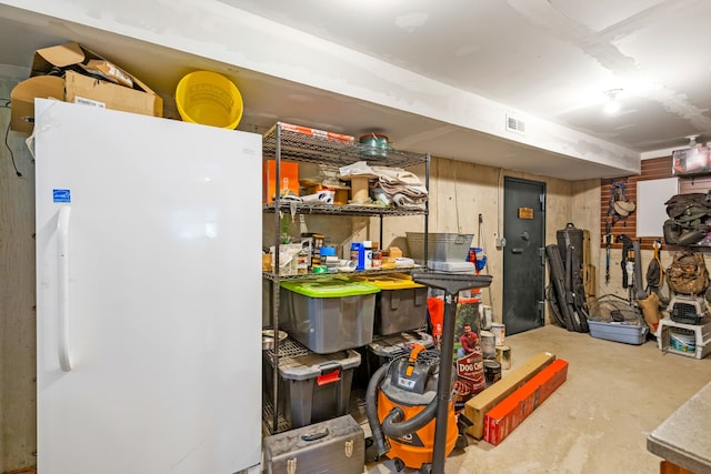 interior space with visible vents and freestanding refrigerator