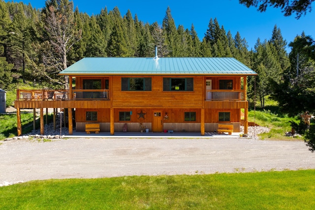 exterior space featuring a wooded view