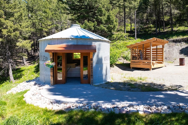 view of outdoor structure with an outdoor structure and a view of trees