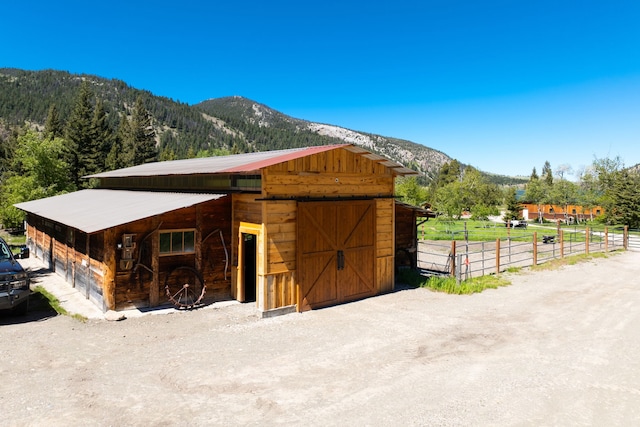 view of stable with a mountain view