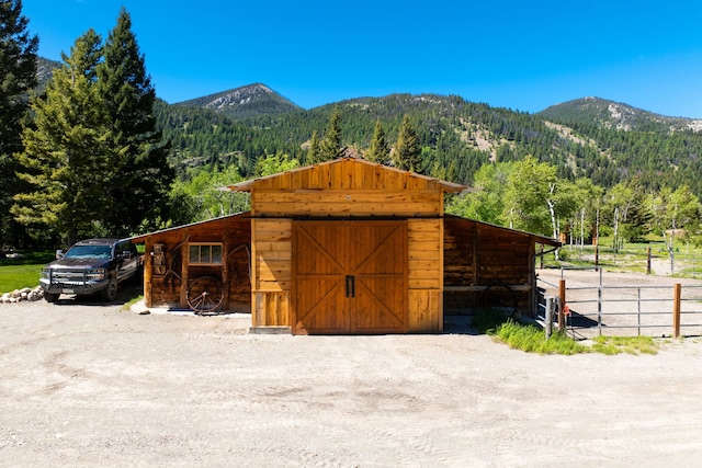 view of outbuilding with an outbuilding, an exterior structure, and a mountain view