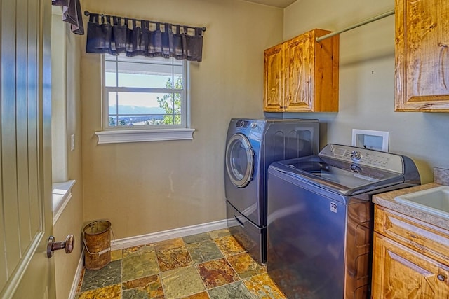 laundry area with cabinets and washing machine and dryer