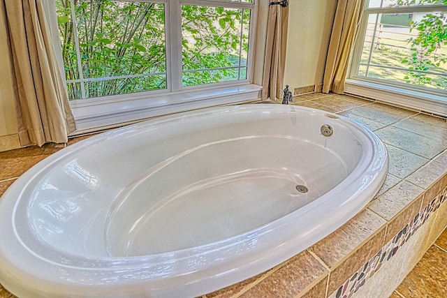 room details with tiled tub and a hot tub