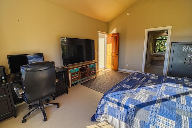 bedroom featuring vaulted ceiling and ensuite bathroom