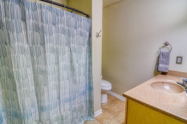 bathroom featuring tile patterned flooring, vanity, curtained shower, and toilet