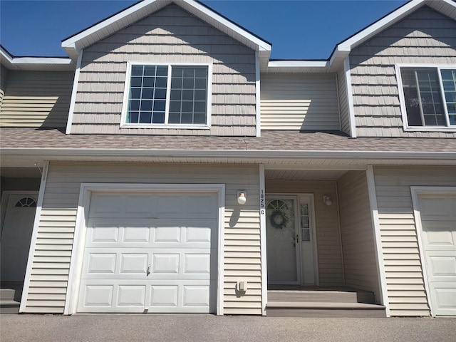 doorway to property with a garage