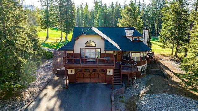 view of front of property featuring a deck and a garage