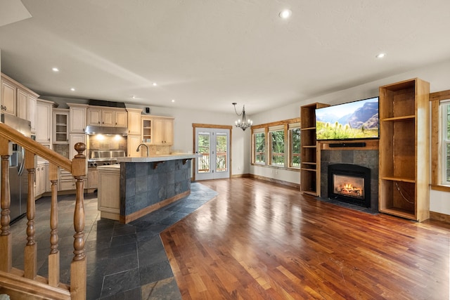 unfurnished living room with a tile fireplace, french doors, and dark wood-type flooring