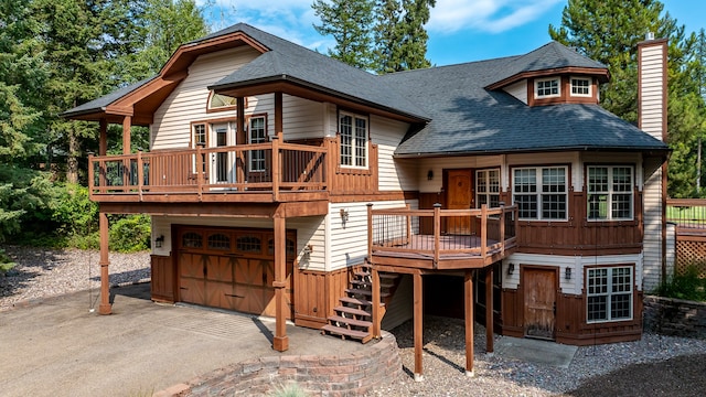 rear view of house with a garage and a deck