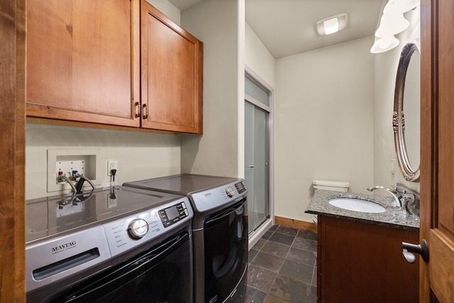 clothes washing area with independent washer and dryer and sink