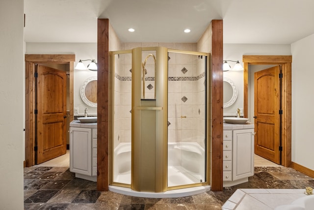 bathroom with vanity and a shower with door