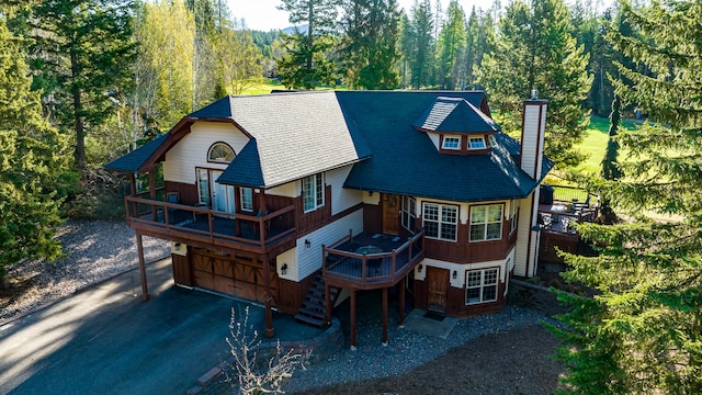 exterior space with a garage and a wooden deck