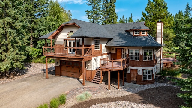 view of front of house with a wooden deck and a garage