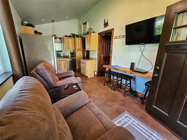 living room with finished concrete flooring and high vaulted ceiling