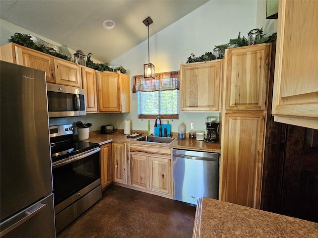 kitchen featuring lofted ceiling, light brown cabinets, stainless steel appliances, a sink, and decorative light fixtures