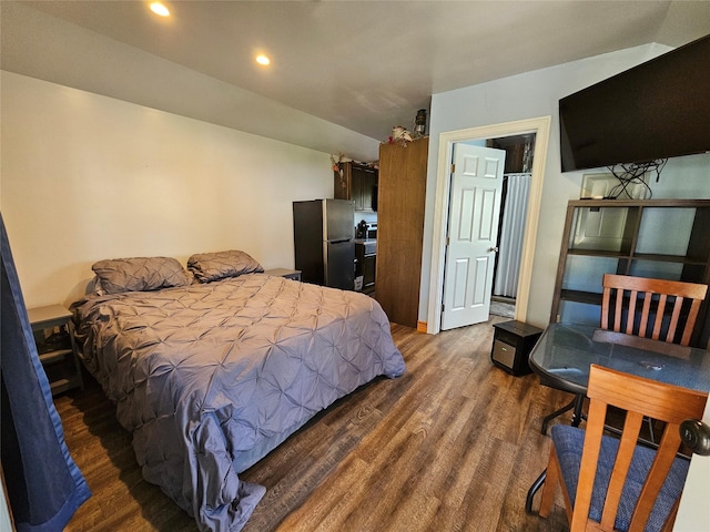 bedroom featuring freestanding refrigerator, dark wood finished floors, and recessed lighting