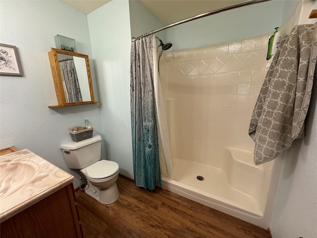 bathroom with vanity, toilet, hardwood / wood-style flooring, and a shower with curtain