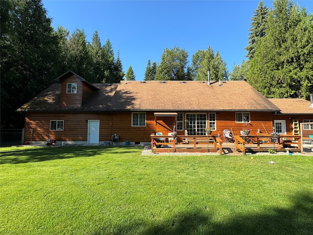 back of house featuring a deck and a yard