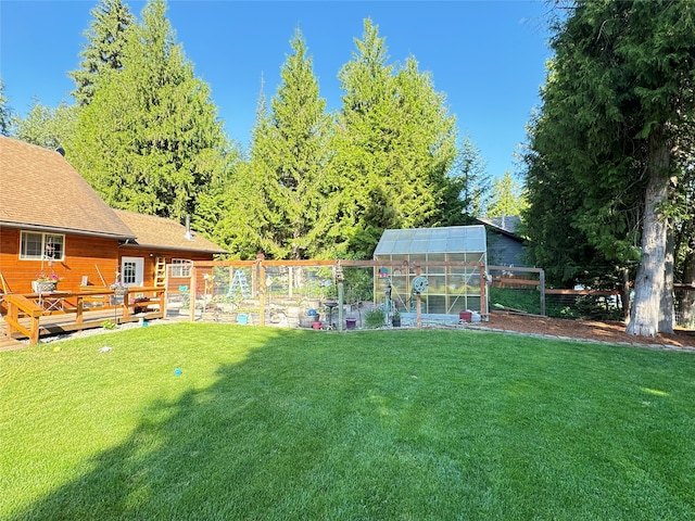 view of yard with a deck and an outbuilding