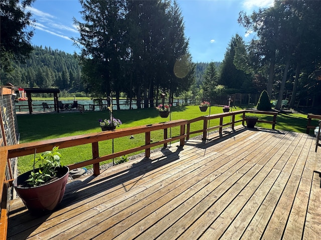 wooden terrace featuring a lawn