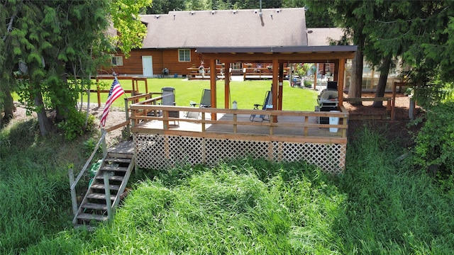 wooden terrace featuring a yard