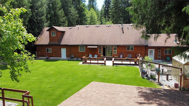 back of property featuring a lawn and a patio area