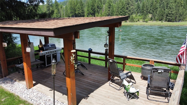 view of dock with a deck with water view