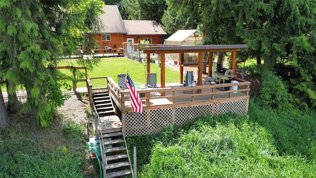 back of house featuring a wooden deck and a lawn