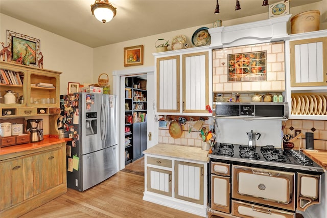 kitchen with stainless steel fridge with ice dispenser, light wood-type flooring, and tasteful backsplash