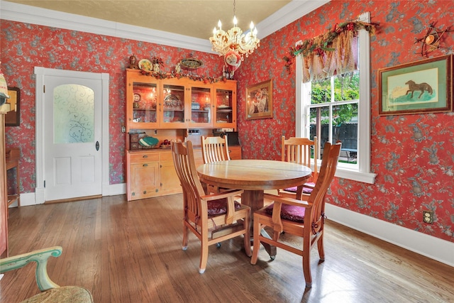 dining space with a chandelier, hardwood / wood-style flooring, and crown molding