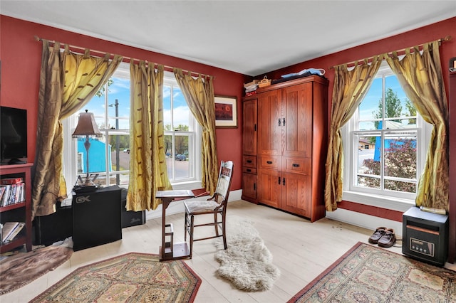 home office with light hardwood / wood-style flooring