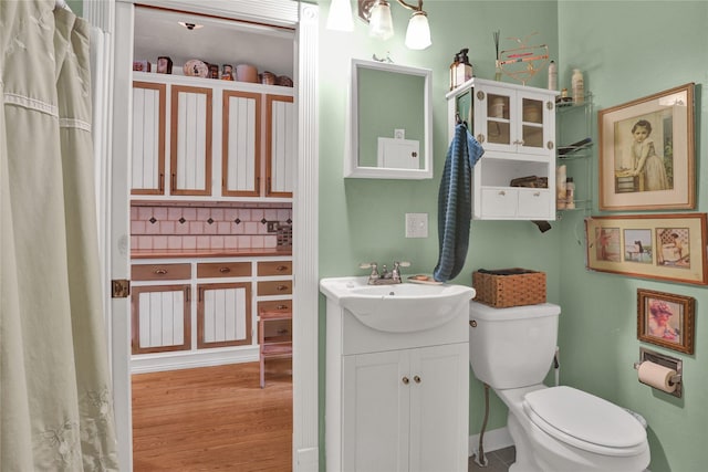 bathroom featuring hardwood / wood-style flooring, vanity, and toilet