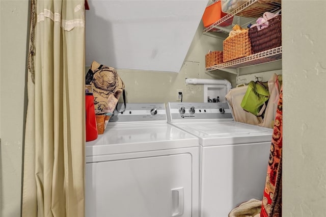 clothes washing area featuring separate washer and dryer