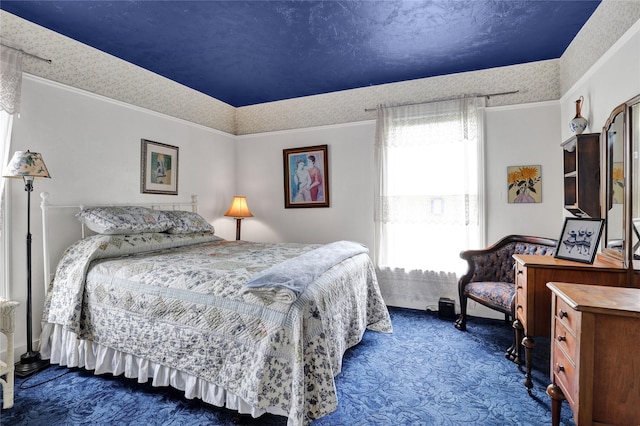 bedroom with dark colored carpet, multiple windows, and crown molding