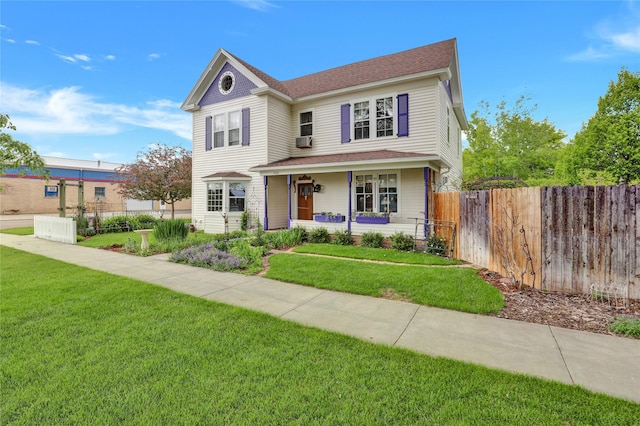 view of front of home with a porch and a front yard