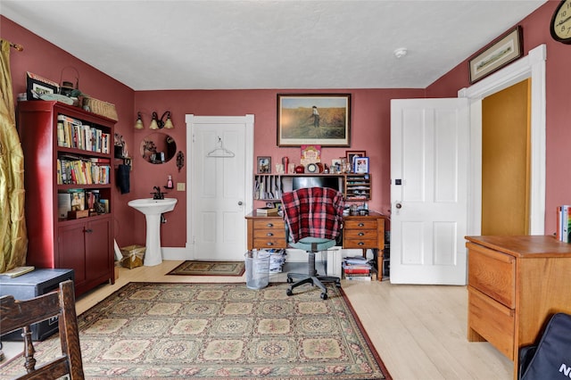 office area featuring sink and light hardwood / wood-style floors