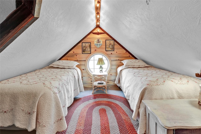 bedroom featuring wood walls and lofted ceiling