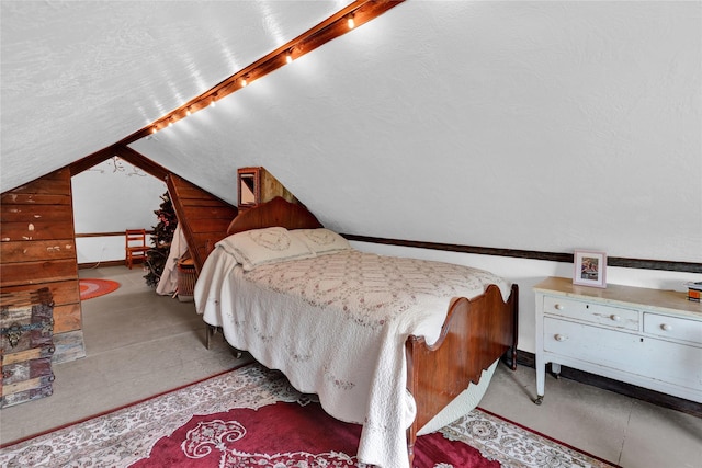 bedroom featuring a textured ceiling and lofted ceiling