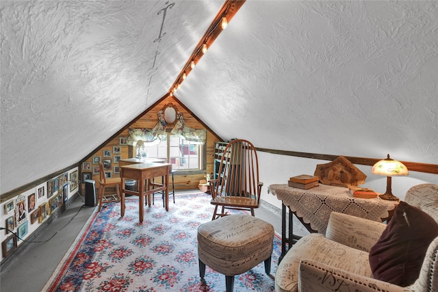 interior space featuring a textured ceiling and lofted ceiling