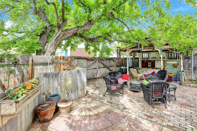 view of patio featuring a gazebo and an outdoor living space with a fire pit