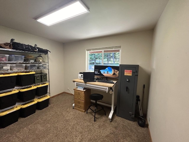 office with baseboards and dark colored carpet