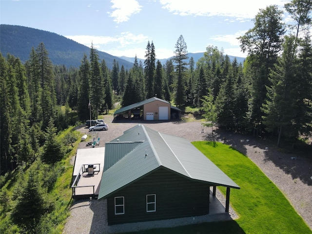 drone / aerial view with a forest view and a mountain view